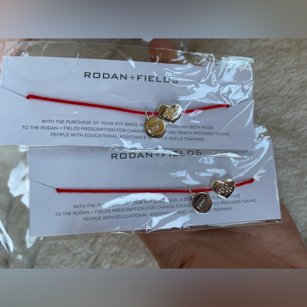 Rodan + Fields Clear Cosmetic Bag with Red Bracelets NEW